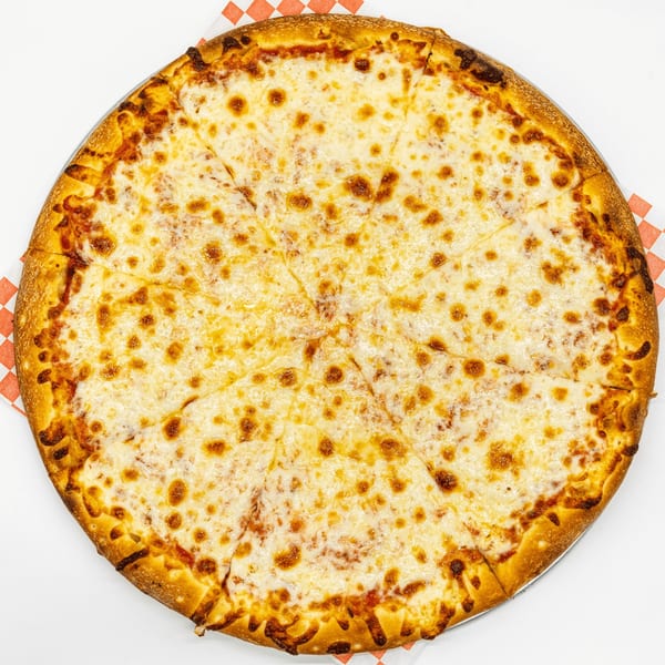 A whole cheese pizza, sliced, on a metal pan with a red and white checkered paper.